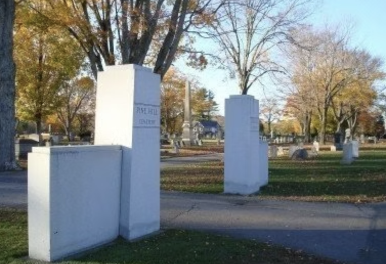 Pine Hill Cemetery entrance with white stone pillars